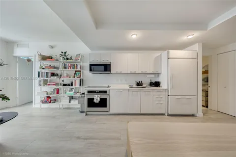 a kitchen with stainless steel appliances cabinets and a refrigerator