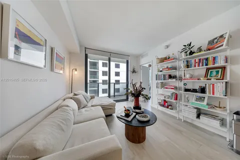 a living room with furniture and a book shelf