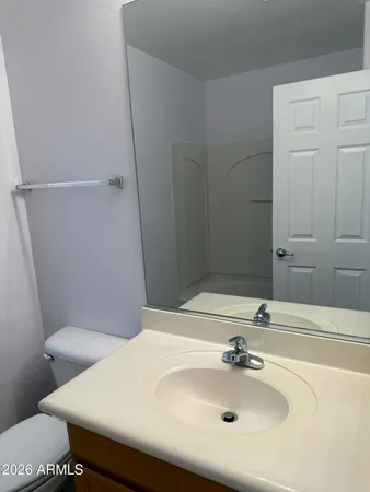 a bathroom with a sink toilet and mirror