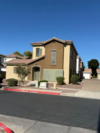 a front view of a house with a road