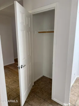 an empty room with wooden floor ceiling fan and windows