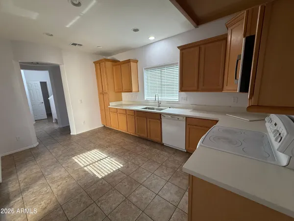a kitchen with a sink stove top oven and cabinets