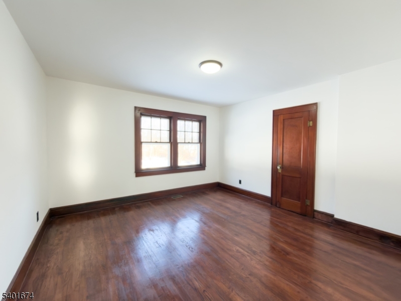 24 Hope Road Great Meadows, NJ 07838 - Photo 4 of 26 an empty room with wooden floor and windows