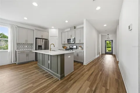 a kitchen with a cabinets and wooden floor