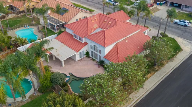 an aerial view of a house with garden space and street view