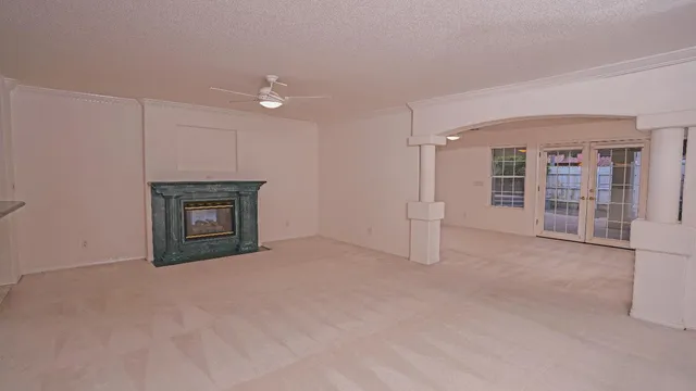 an empty room with furniture and a fireplace