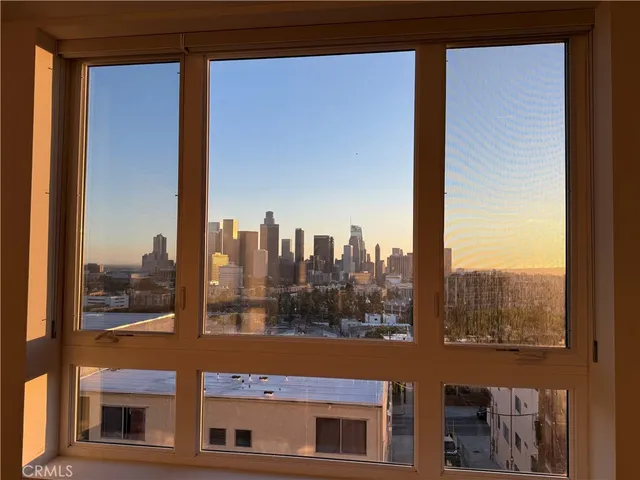 a dining room with furniture and a potted plant