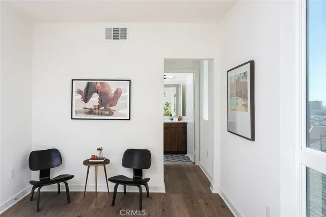 a balcony with wooden floor and city view