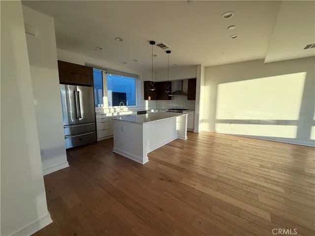 a kitchen with stainless steel appliances granite countertop a stove and a refrigerator