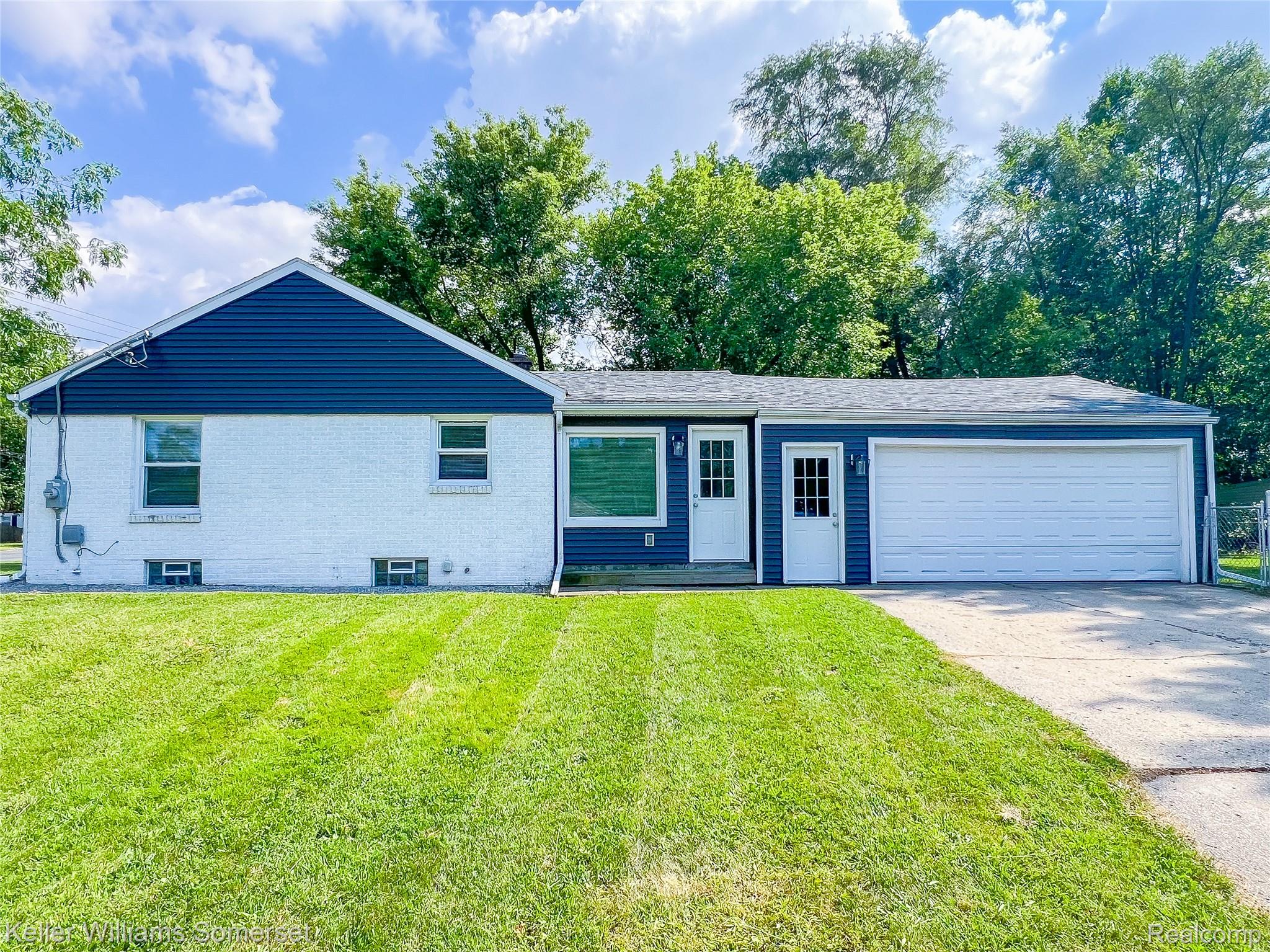 1821 Nazareth Road Kalamazoo, MI 49048 - Photo 23 of 24 Blue vinyl siding and white brick exterior