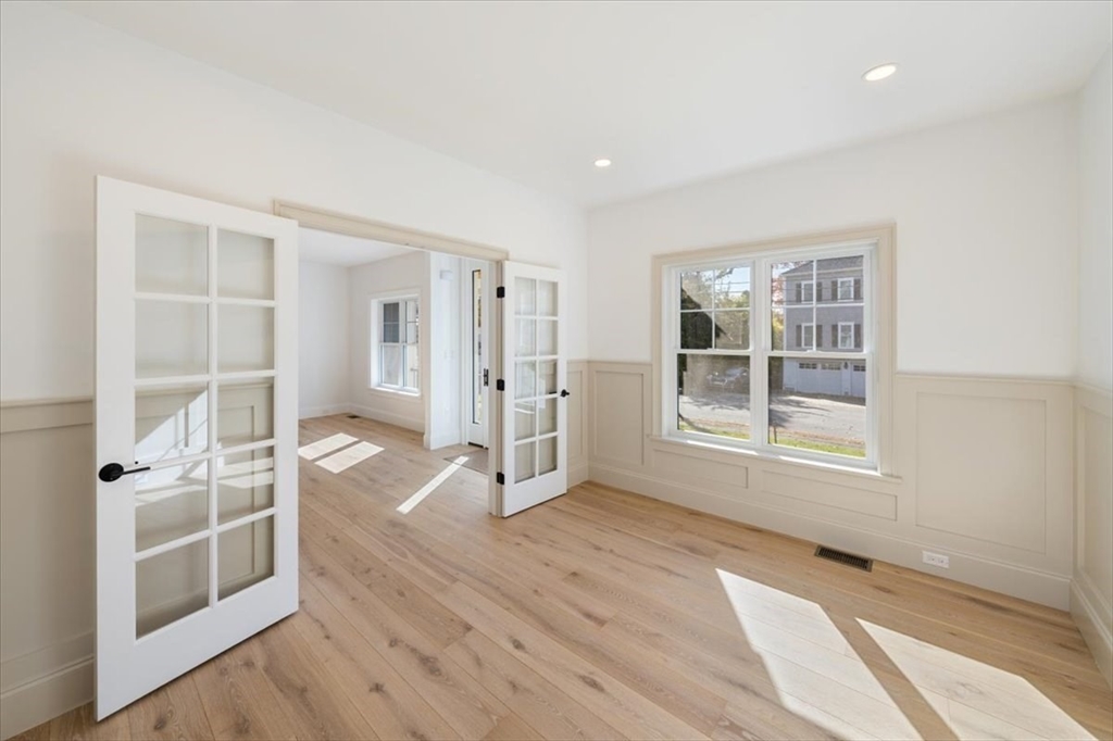 17 Harwood Road Natick, MA 01760 - Photo 5 of 20 an empty room with wooden floor and a window