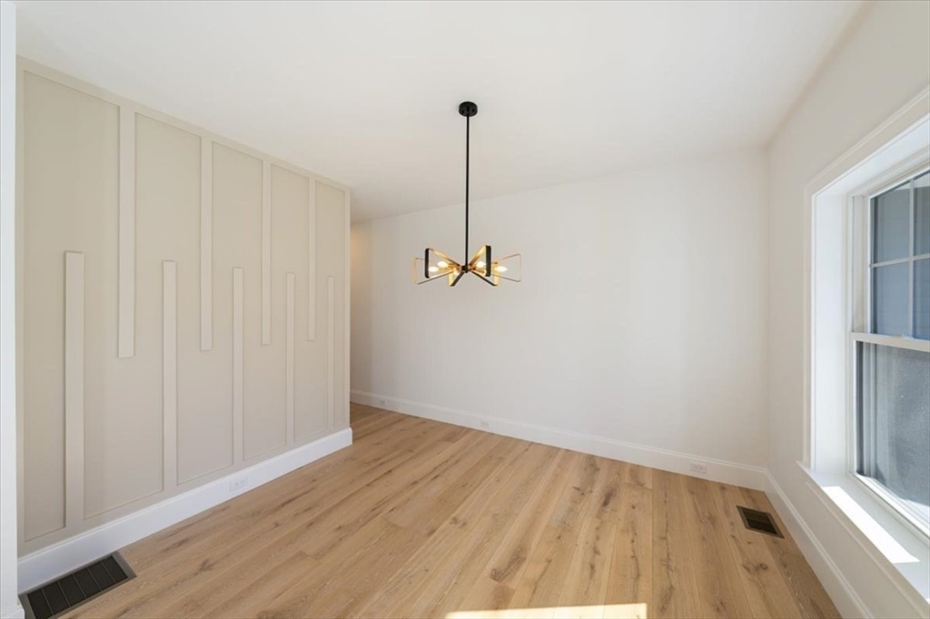 17 Harwood Road Natick, MA 01760 - Photo 6 of 20 a view of a room with wooden floor and white walls