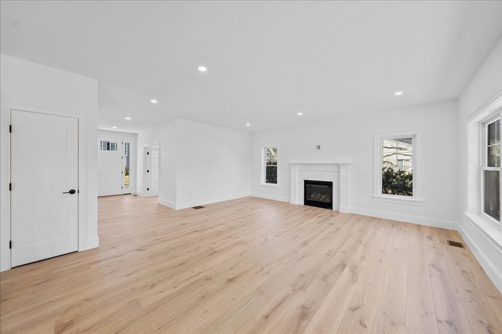 17 Harwood Road Natick, MA 01760 - Photo 7 of 20 a view of empty room with wooden floor and fireplace
