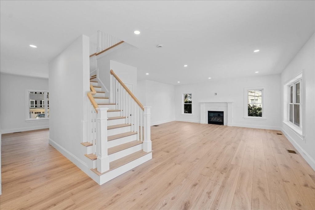 17 Harwood Road Natick, MA 01760 - Photo 8 of 20 a view of a livingroom with wooden floor staircase and kitchen space