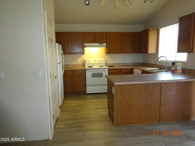 a kitchen with a stove a sink and a microwave