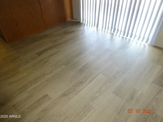 a view of a room with wooden floor