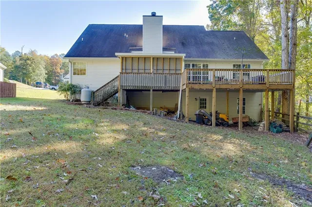 a view of a house with a yard and sitting area