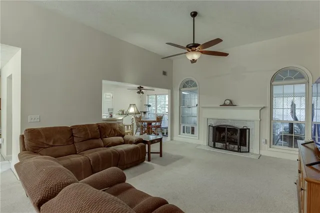 a living room with furniture a fireplace and a chandelier