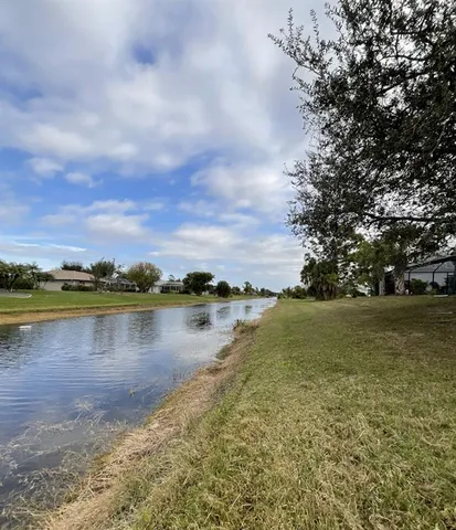 a view of a lake with houses in the back