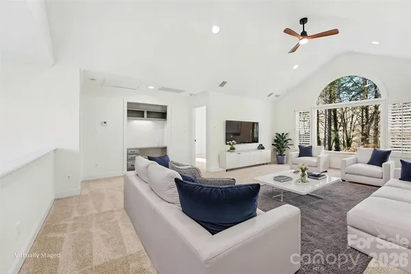a bathroom with a granite countertop sink a toilet and a mirror