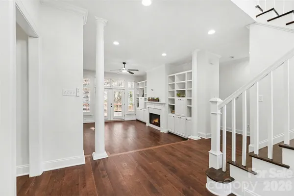 a view of a kitchen with wooden floor and electronic appliances