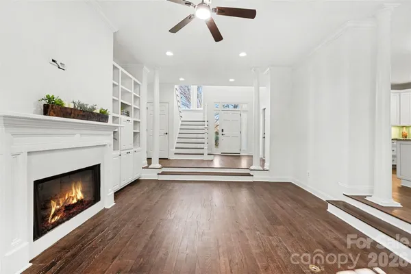 a view of a kitchen with wooden floor and a large window