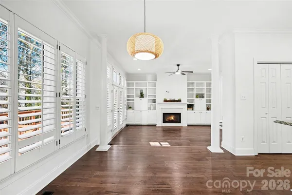 a view of a livingroom with wooden floor and a fireplace