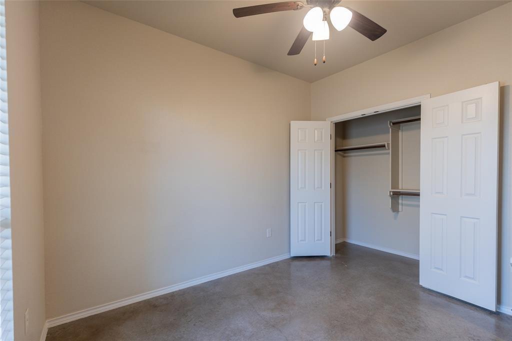 351 Joanne Loop, Unit A Buda, TX 78610 - Photo 11 of 17 A quiet bedroom features durable concrete flooring, offering an appealing blank canvas for customization.