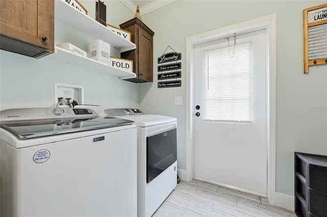 a spacious bedroom with a bed and a chandelier