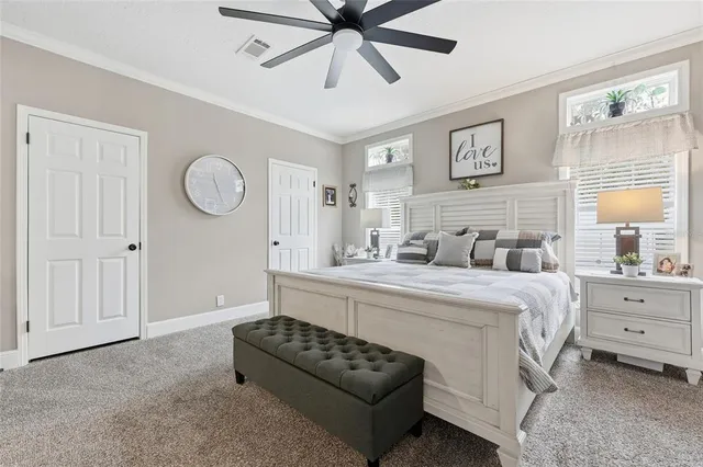 a spacious bedroom with a bed and a window