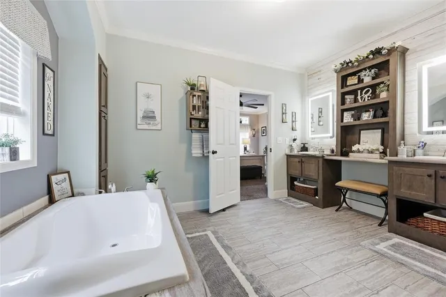 a bathroom with a granite countertop sink and a toilet