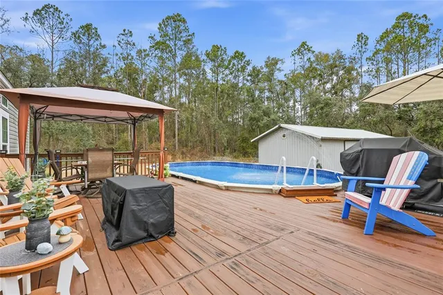 a front view of a house with a garden and trees