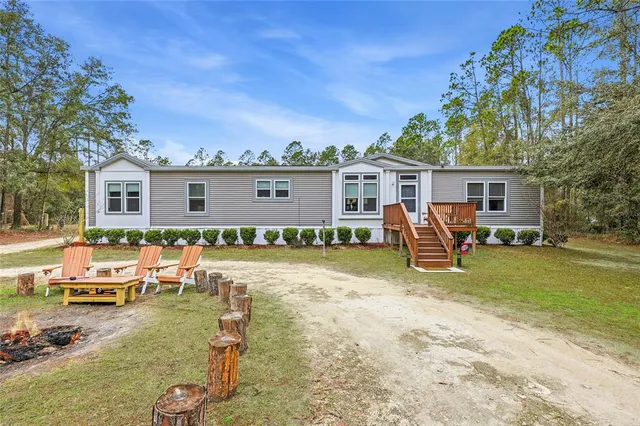 a kitchen with stainless steel appliances granite countertop a sink counter space cabinets and a large window