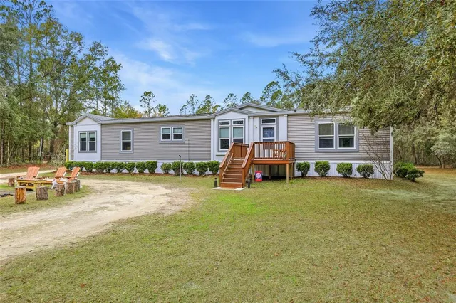 a kitchen with stainless steel appliances granite countertop a sink and a refrigerator