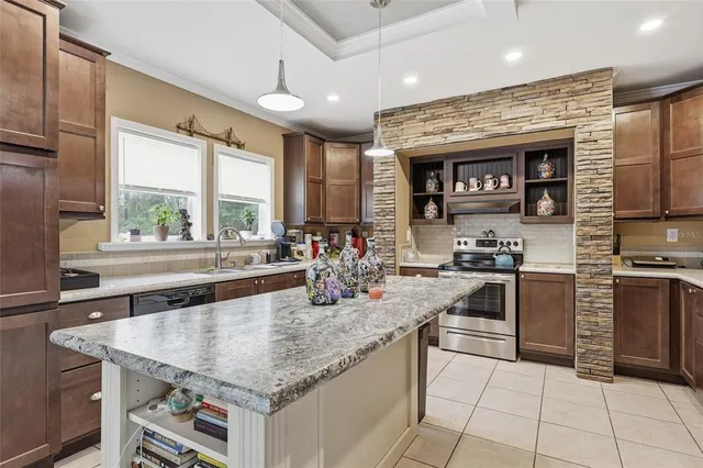a dining room with furniture and a floor to ceiling window