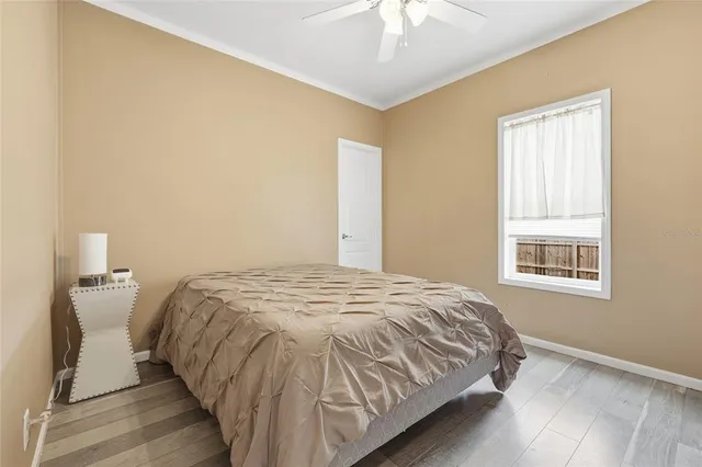 a living room with furniture a flat screen tv and a window