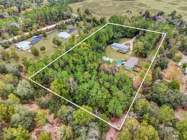 a view of a house with yard and sitting area