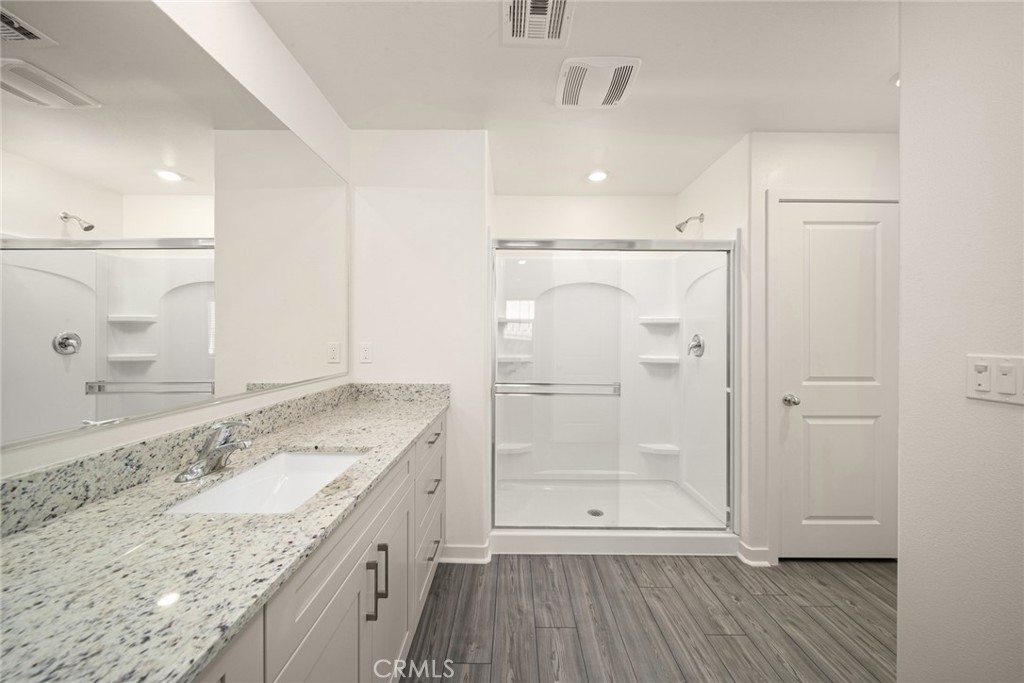 42499 Aruba Court Indio, CA 92201 - Photo 18 of 22 a bathroom with a granite countertop sink mirror and shower