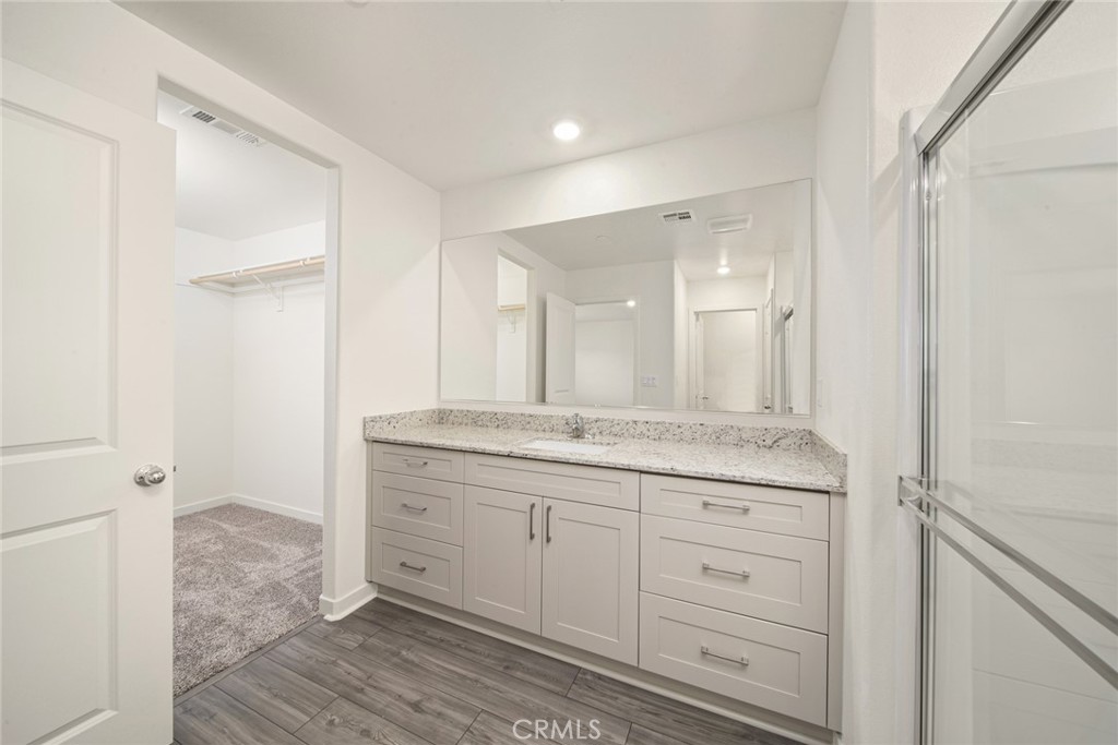 42499 Aruba Court Indio, CA 92201 - Photo 19 of 22 a bathroom with a granite countertop sink two mirror and a