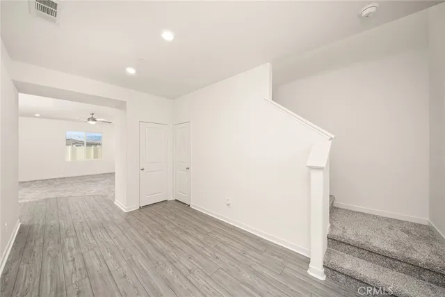 a view of hallway with wooden floor