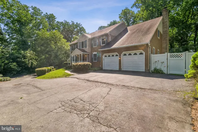 a view of a house with a yard and covered with wooden fence