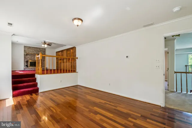 a view of an empty room with a fireplace and a window