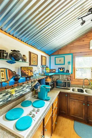a kitchen with stainless steel appliances granite countertop a sink and cabinets