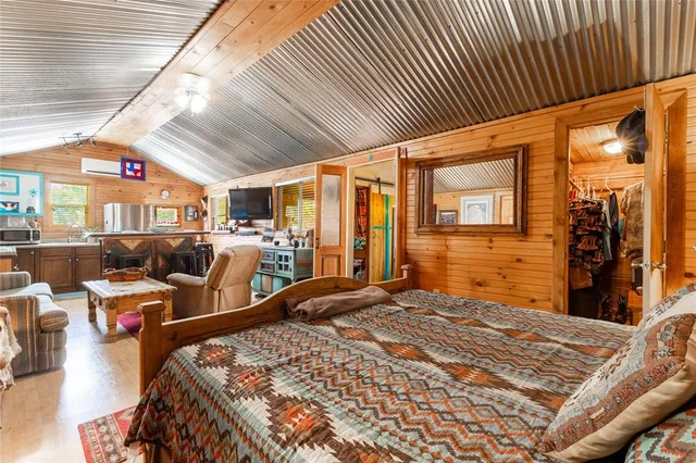 a bedroom with a bed and a painting on the wall