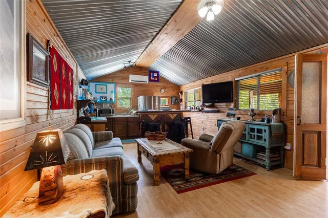 a living room with furniture a flat screen tv and a floor