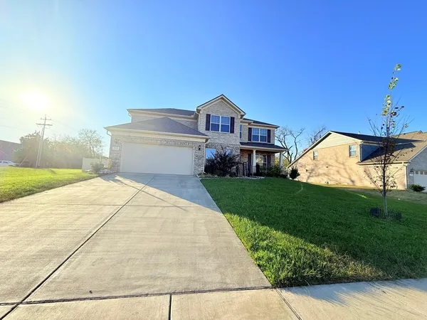 a front view of a house with a yard and garage