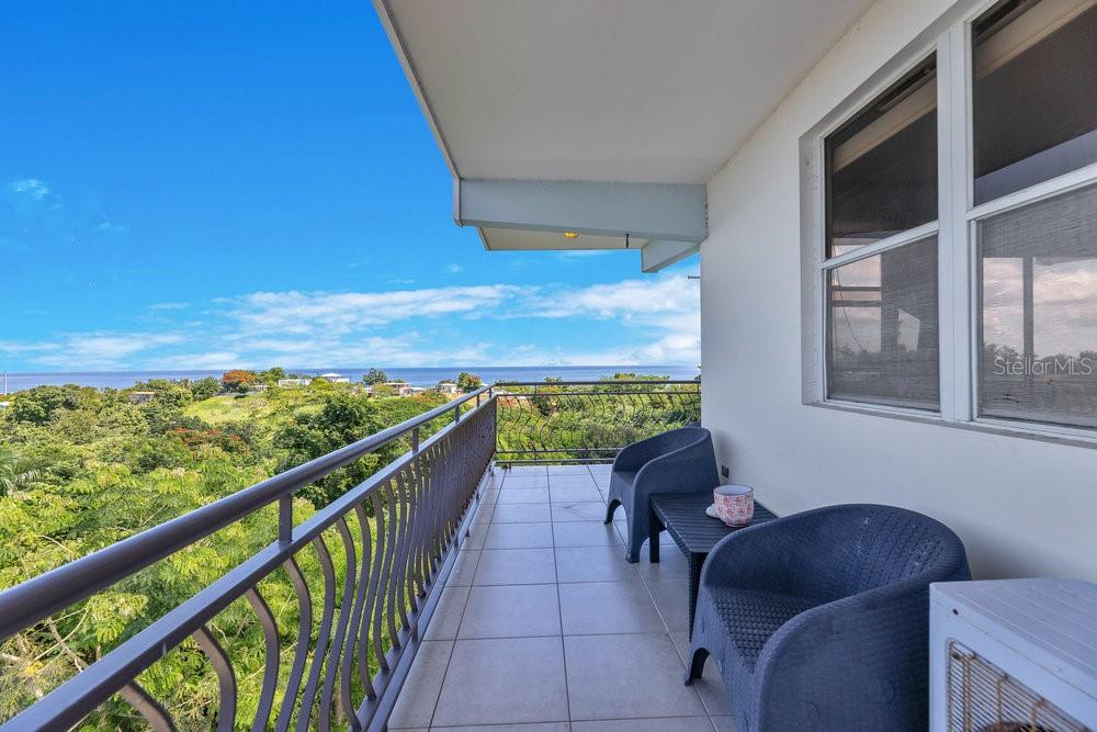 413 Camino Carretas, Unit A7 Rincon, Rincón 00677 - Photo 4 of 23 a view of two chairs in a balcony