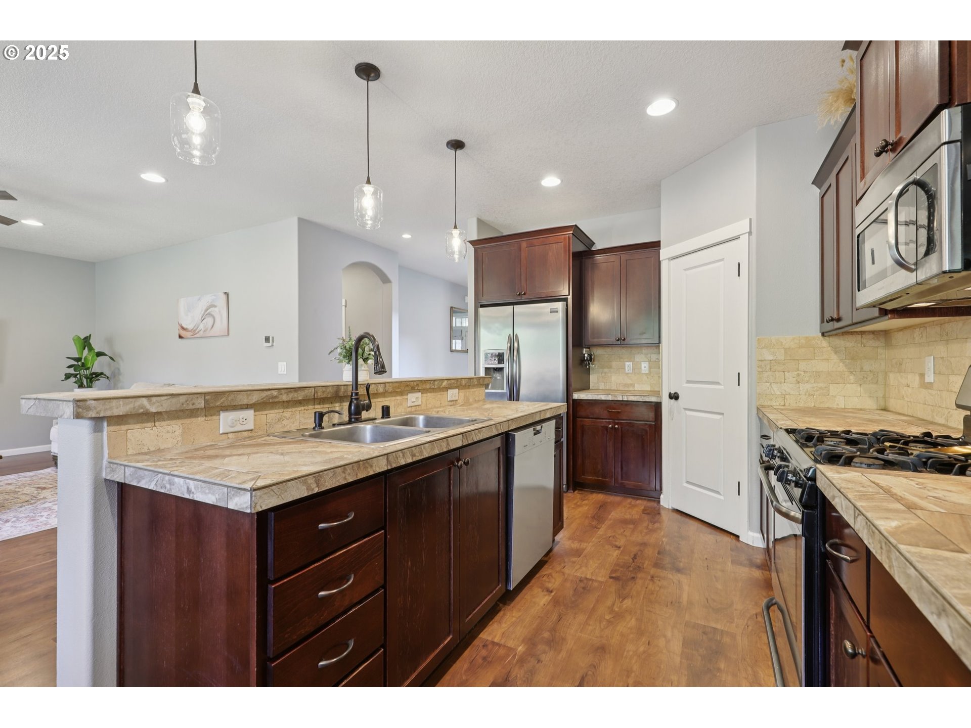 3520 North 6th Circle Ridgefield, WA 98642 - Photo 11 of 27 a kitchen with a sink stove and refrigerator