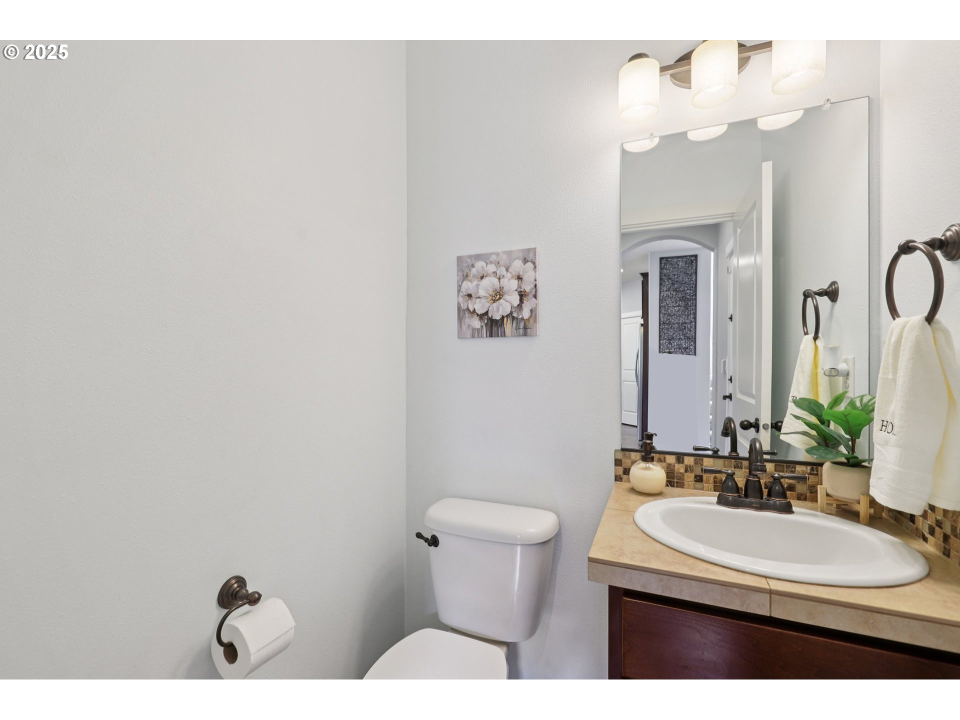 3520 North 6th Circle Ridgefield, WA 98642 - Photo 17 of 27 a bathroom with a sink a toilet and mirror