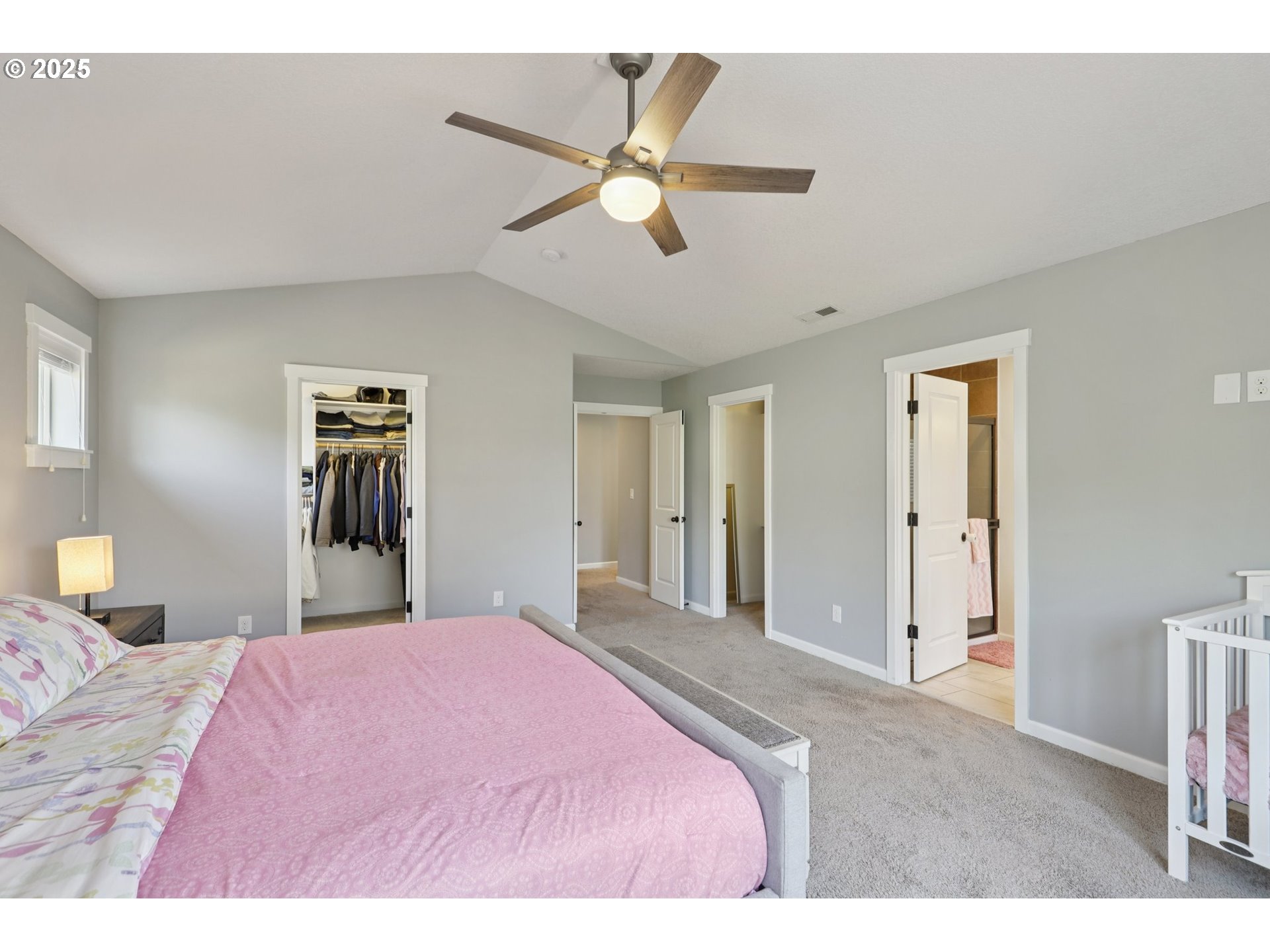 3520 North 6th Circle Ridgefield, WA 98642 - Photo 21 of 27 a bedroom with a large bed and a chandelier
